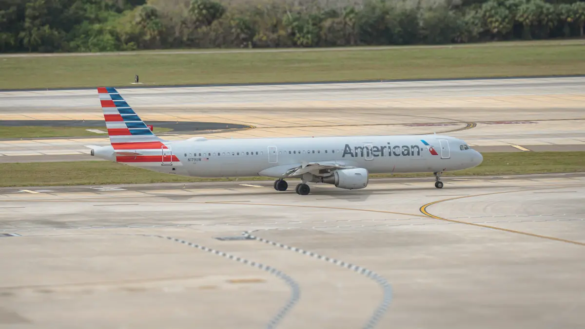 A passenger jet taxiing on an airport runway
